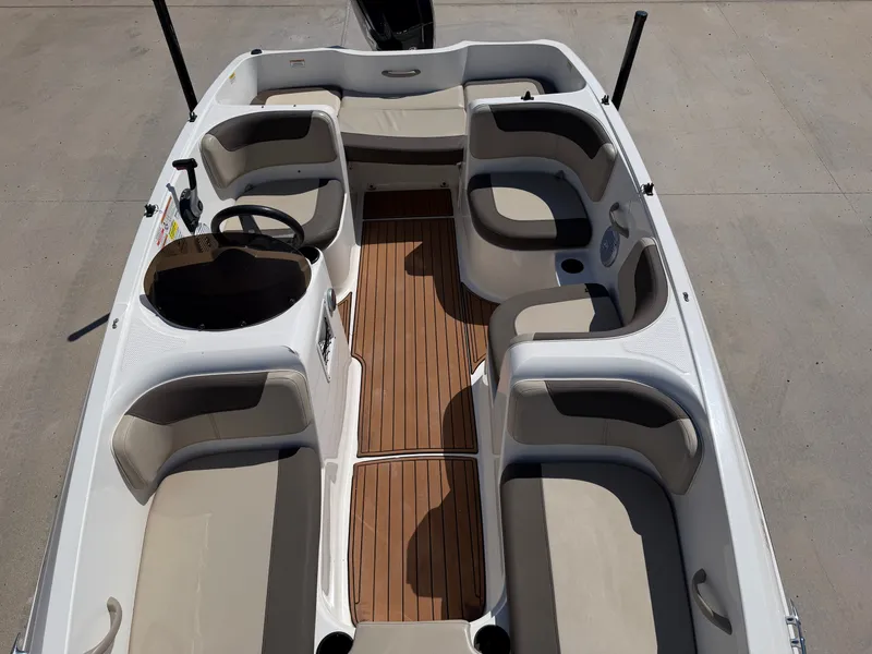 Slide: The Image of The image shows the interior of a 2017 Bayliner Element 16 boat with seating and wood flooring. - 14