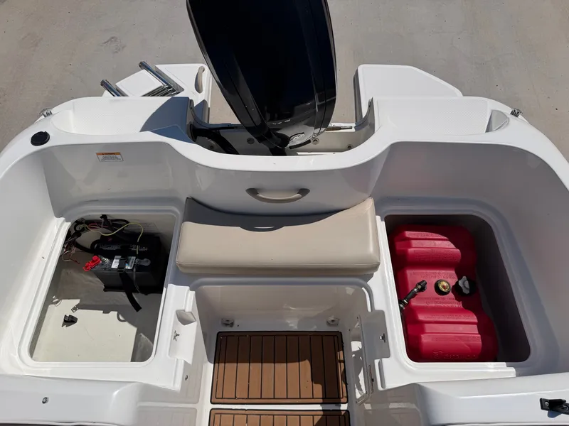 Slide: The Image of The image shows the stern of a 2017 Bayliner Element 16 boat with storage and fuel tank. - 24