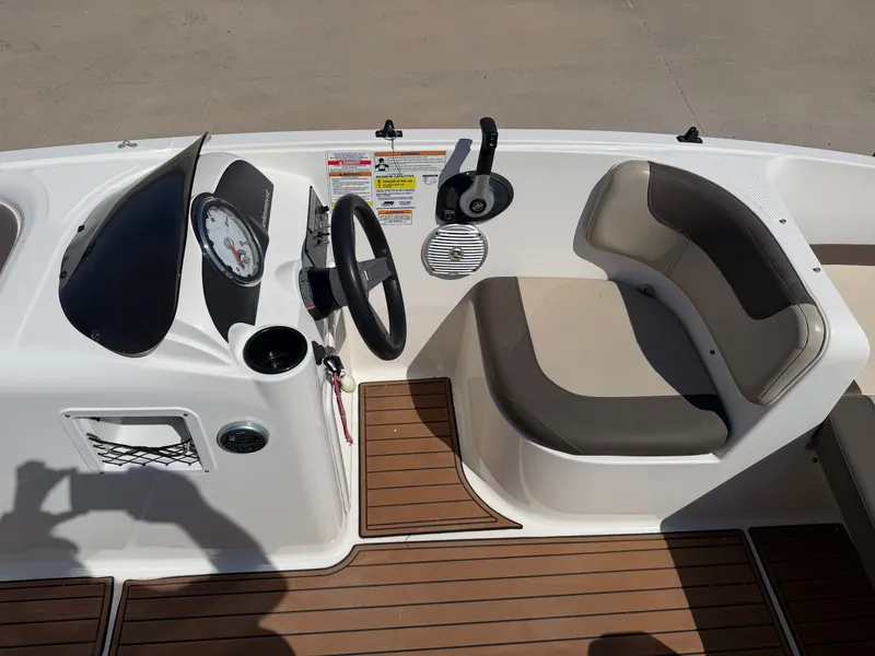 Slide: The Image of The image shows the cockpit of a 2017 Bayliner Element 16 with a steering wheel and seating. - 18