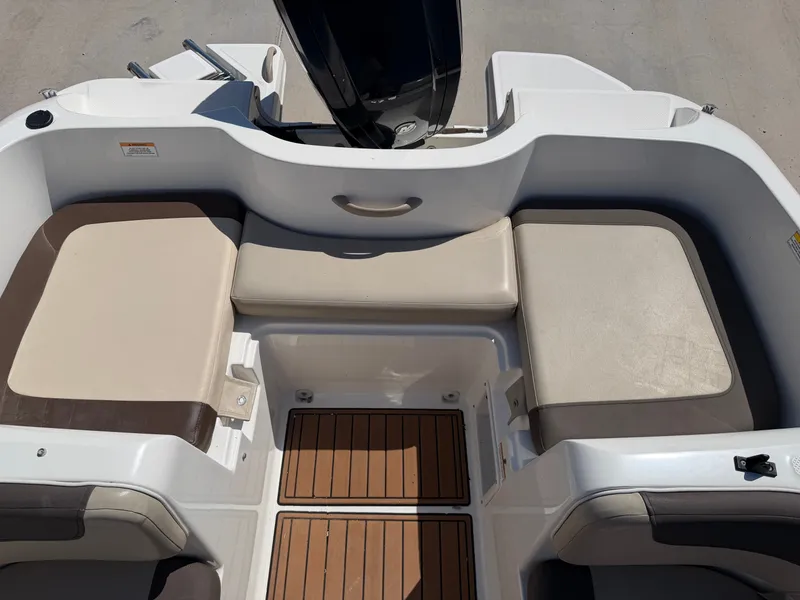 Slide: The Image of The image shows the seating area of a 2017 Bayliner Element 16 boat with cushioned seats. - 23