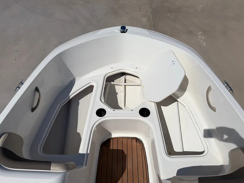 Slide: The Image of The image shows the bow area of a 2017 Bayliner Element 16 with seating and storage. - 15
