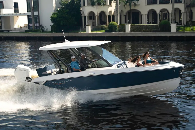 Slide: The Image of Manufacturer Provided Image: 2025 Monterey Elite 27 OB boat cruising on a river with passengers enjoying the ride. - 23