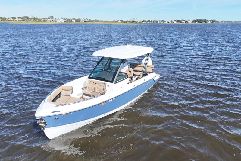 Slide: The Image of 2025 Monterey Elite 27 OB boat cruising on open water. - 4