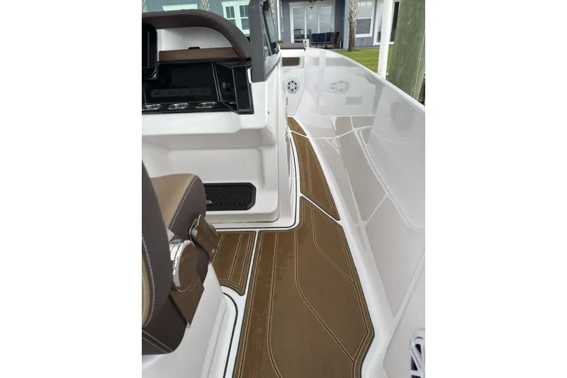 Slide: The Image of 2025 Monterey Elite 27 OB boat interior with sleek brown flooring and modern design. - 47