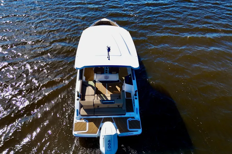 Slide: The Image of 2025 Monterey Elite 27 OB boat cruising on open water, aerial view. - 21