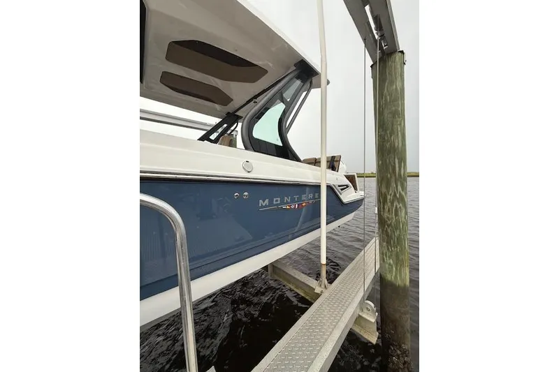 Slide: The Image of 2025 Monterey Elite 27 OB boat docked, showcasing sleek design and modern features. - 39