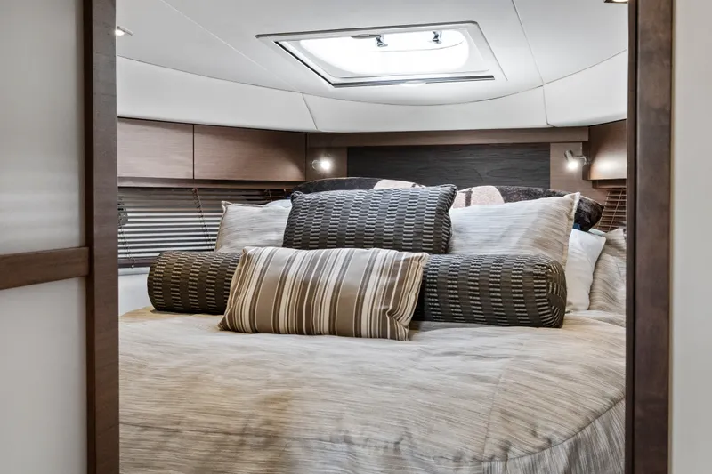 Slide: The Image of Luxurious cabin interior of 2013 Sea Ray 410 Sundancer yacht with plush bedding. - 6