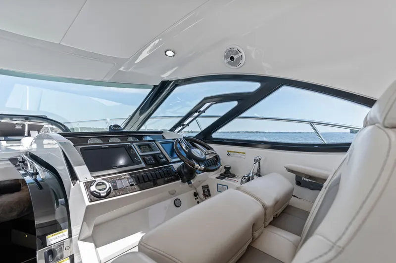 Slide: The Image of Interior helm of 2013 Sea Ray 410 Sundancer yacht with modern controls and ocean view. - 35
