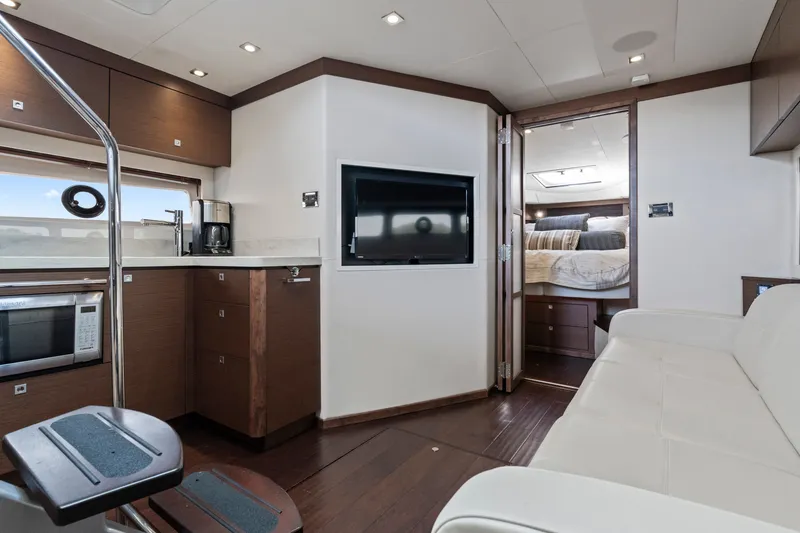Slide: The Image of Luxurious interior of 2013 Sea Ray 410 Sundancer yacht with modern kitchen and cozy seating. - 17