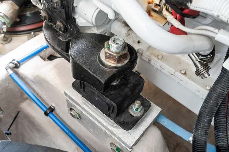 Slide: The Image of Engine component of a 2013 Sea Ray 410 Sundancer boat, featuring bolts and hoses. - 49