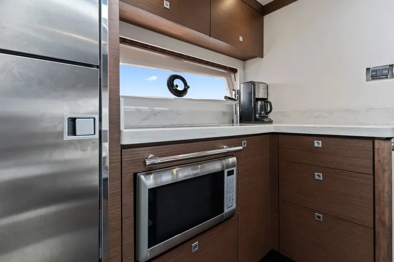 Slide: The Image of Modern galley kitchen in 2013 Sea Ray 410 Sundancer yacht with microwave and coffee maker. - 16