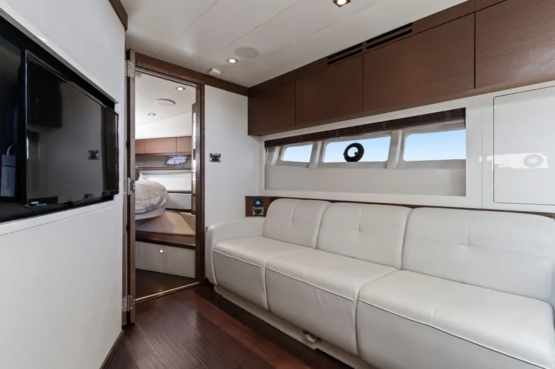 Slide: The Image of Luxurious interior of 2013 Sea Ray 410 Sundancer yacht with white leather seating and modern design. - 13