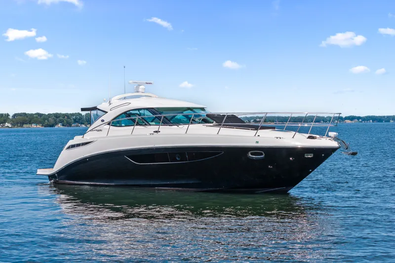 Slide: The Image of 2013 Sea Ray 410 Sundancer yacht on calm blue water. - 3