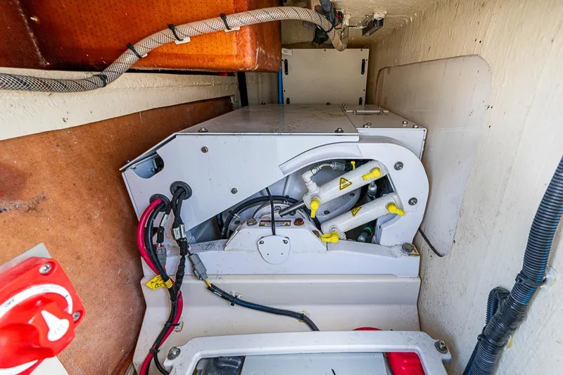 Slide: The Image of Engine compartment of a 2021 Scout 330 LXF boat, showcasing mechanical components. - 22