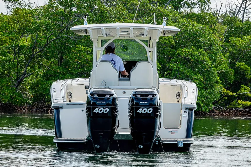 Slide: The Image of 2021 Scout 330 LXF boat with dual 400 Verado engines on water. - 8