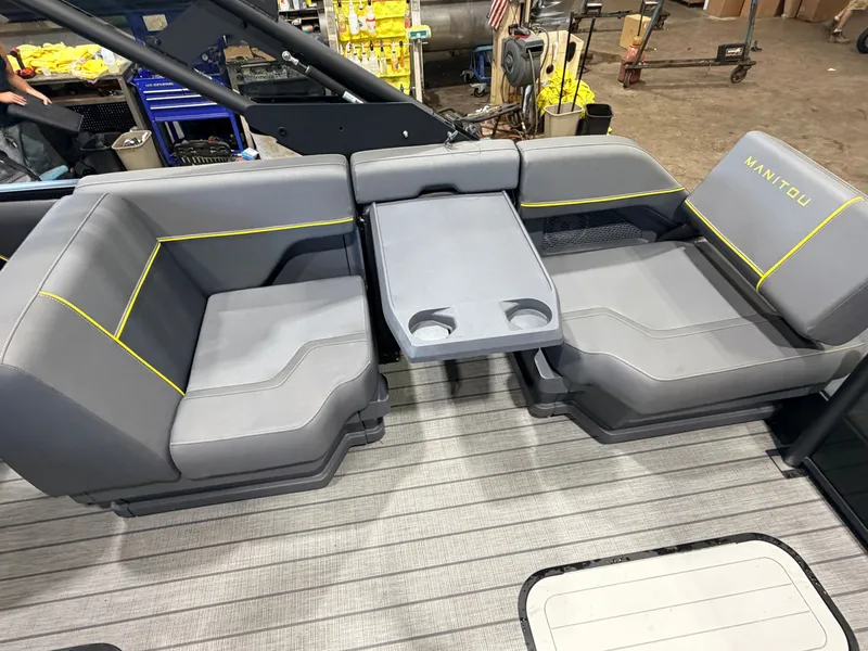 Slide: The Image of Gray seating area with yellow accents and a table with cup holders on a boat. - 44