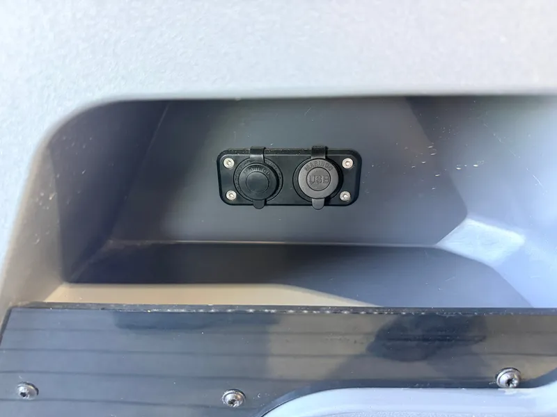 Slide: The Image of Close-up of a charging port on a boat, set into a gray wall. - 17