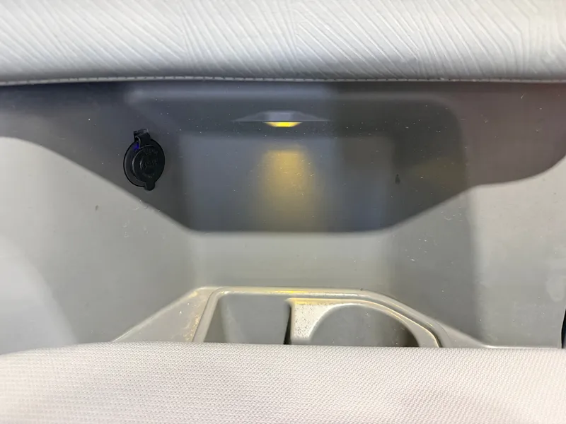 Slide: The Image of Close-up of a lit storage compartment with an outlet in a boat. - 12