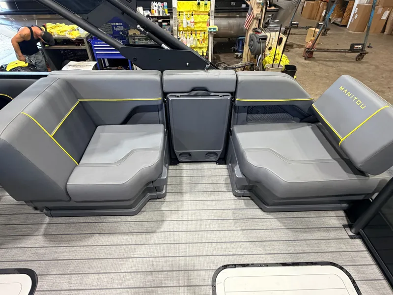 Slide: The Image of Gray seats with yellow accents are on a boat named Manitou. - 43