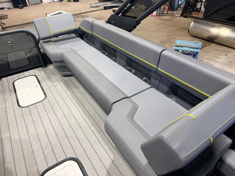 Slide: The Image of The image shows the gray seating of a 2023 Manitou 22 Explore Tritoon. - 34