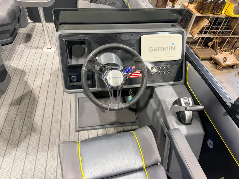 Slide: The Image of The image shows the helm of a Manitou 22 Explore Tritoon with a Garmin display. - 21