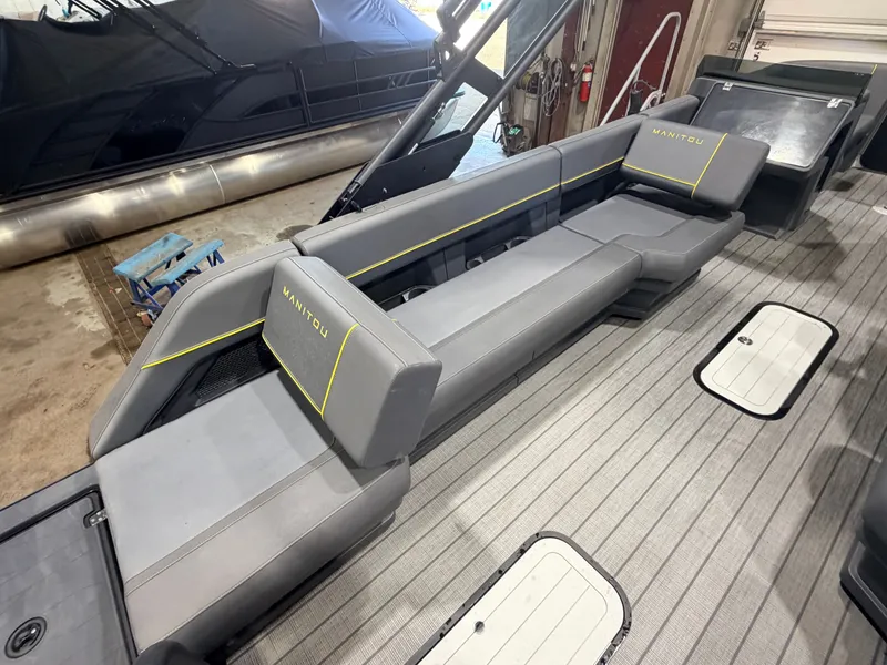 Slide: The Image of The image shows the gray seating of a Manitou 22 Explore Tritoon with yellow accents. - 39