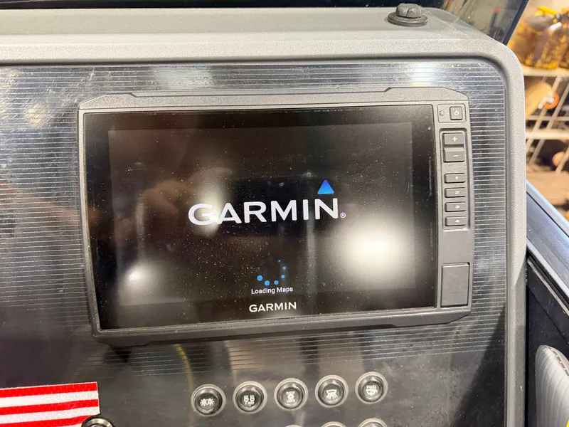 Slide: The Image of Garmin navigation system on a boat with several buttons below. - 23