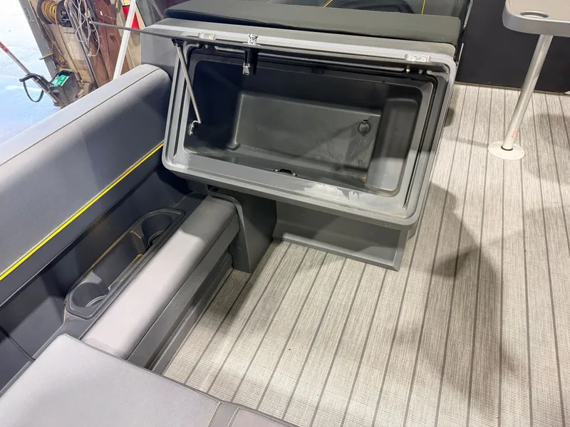 Slide: The Image of Interior of a Manitou 22 Explore Tritoon with gray upholstery and storage compartment. - 30