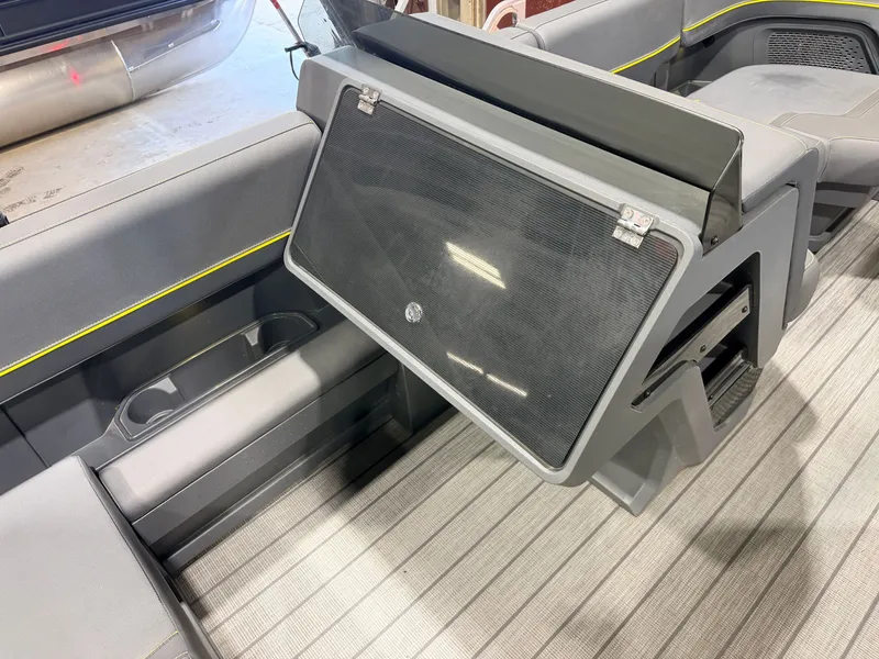 Slide: The Image of The image shows the interior of a 2023 Manitou 22 Explore Tritoon with gray seating and yellow accents. - 29