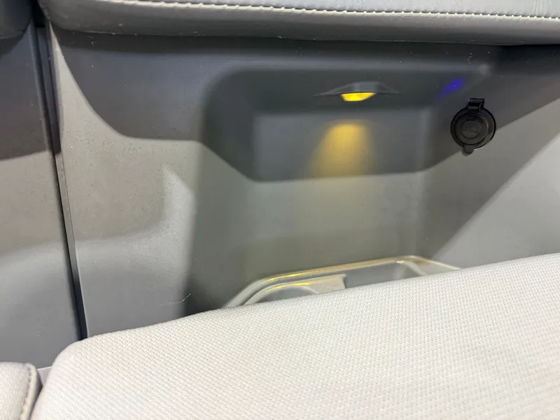Slide: The Image of Close-up of a seating area with lighting and outlet on a Manitou 22 Explore Tritoon. - 15