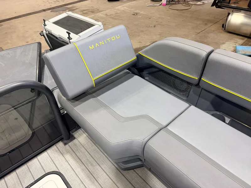 Slide: The Image of The image shows a gray seating area on a Manitou boat with yellow accents. - 37