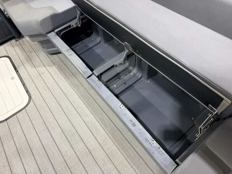 Slide: The Image of The 2023 Manitou 22 Explore Tritoon features an open storage compartment beneath the seating. - 36