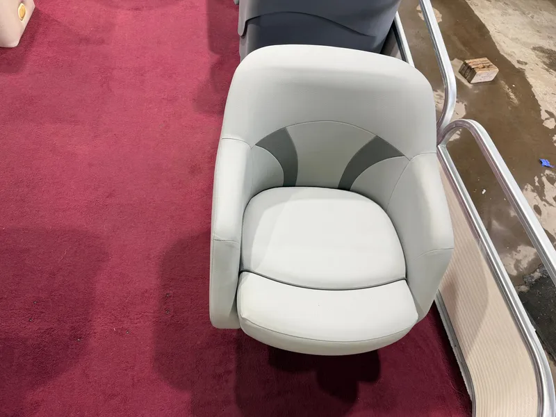 Slide: The Image of A white boat seat on red carpet flooring, surrounded by metal railings. - 14