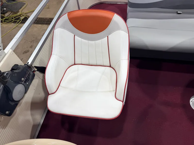 Slide: The Image of A white boat seat with red accents on a maroon carpeted floor. - 20