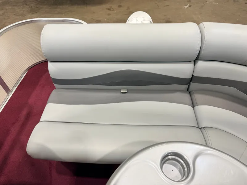 Slide: The Image of Gray upholstered bench on a boat with red carpet flooring. - 33