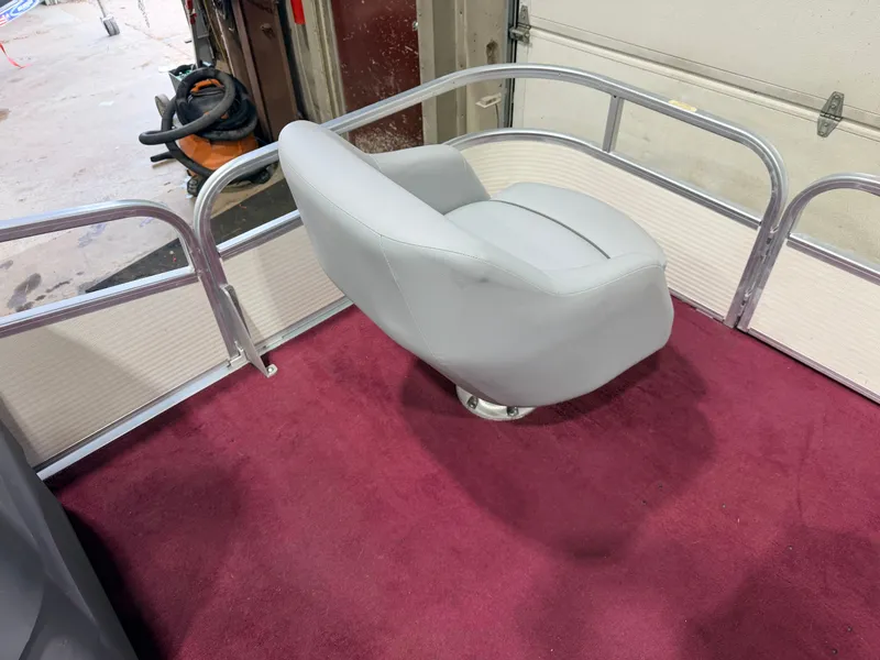 Slide: The Image of A gray seat on a boat with red carpet flooring. - 15