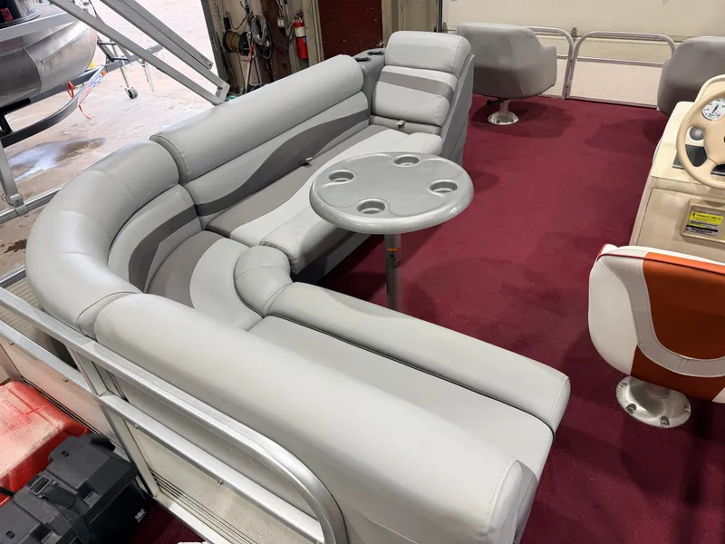 Slide: The Image of Interior of a 1998 Premier 180 Horizon with gray upholstered seating and a small table. - 36