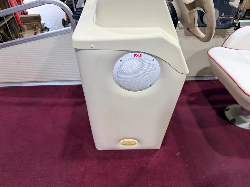 Slide: The Image of A speaker is installed in a white console on a boat, surrounded by red carpet. - 19