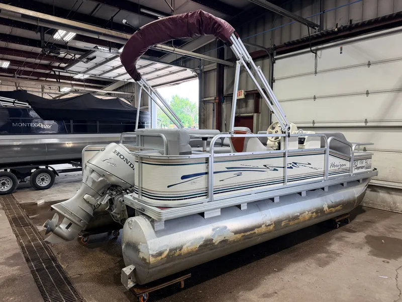 Slide: The Image of A 1998 Premier 180 Horizon pontoon boat with a 40HP Honda 4-stroke engine in a garage. - 46
