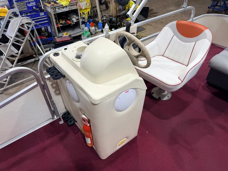 Slide: The Image of The image shows the cockpit of a 1998 Premier 180 Horizon boat with a white seat and red accent. - 17