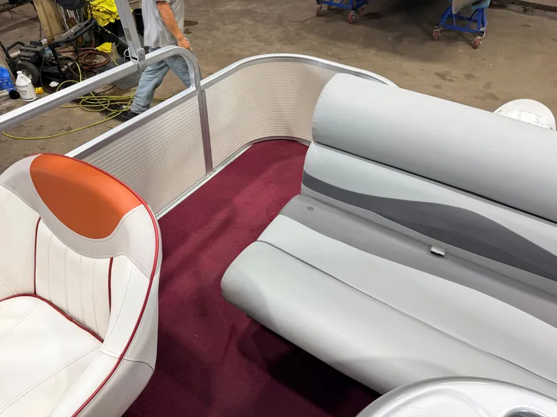 Slide: The Image of Interior of a 1998 Premier 180 Horizon with gray and white seating on red carpet. - 35