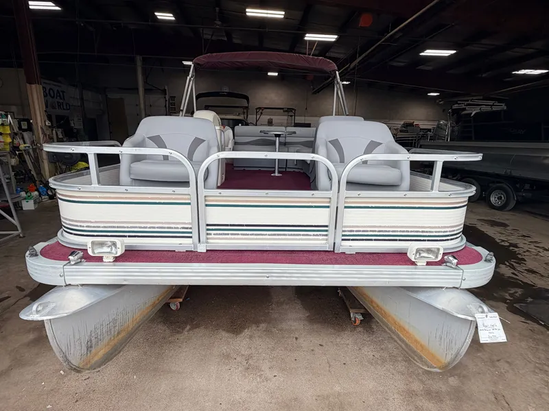 Slide: The Image of A 1998 Premier 180 Horizon pontoon boat with a 40HP Honda 4-stroke engine, in a warehouse. - 37