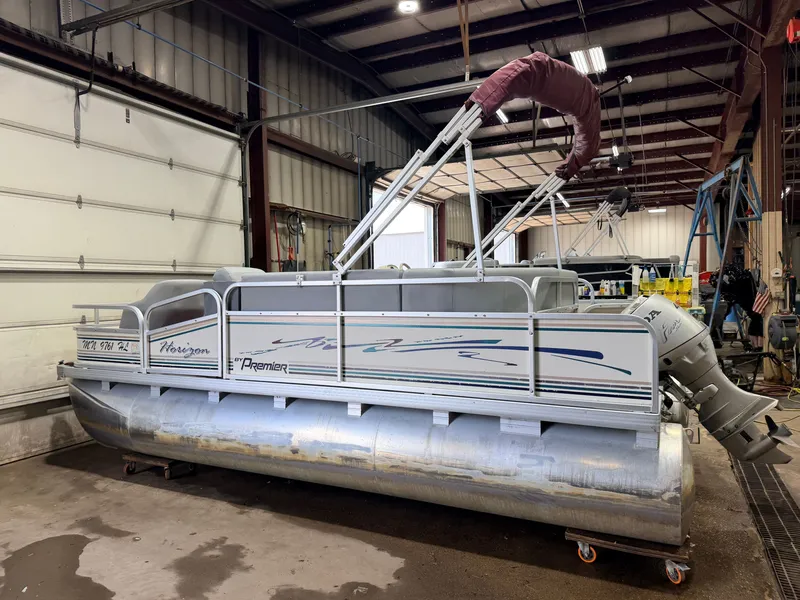 Slide: The Image of A 1998 Premier 180 Horizon pontoon boat with a 40HP Honda 4-stroke engine in a workshop. - 41