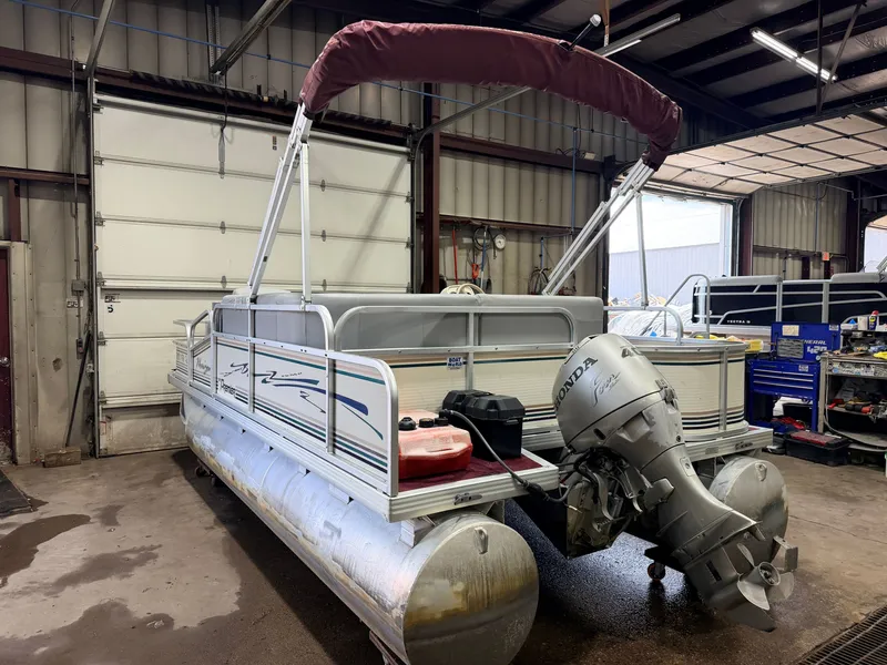 Slide: The Image of A 1998 Premier 180 Horizon pontoon boat with a 40HP Honda 4-stroke engine in a workshop. - 43