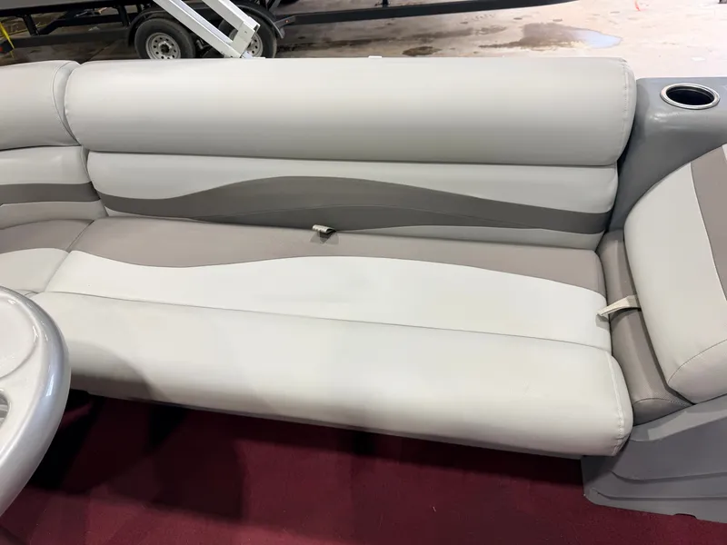 Slide: The Image of Gray and white bench seat with cup holder on red carpet flooring. - 31