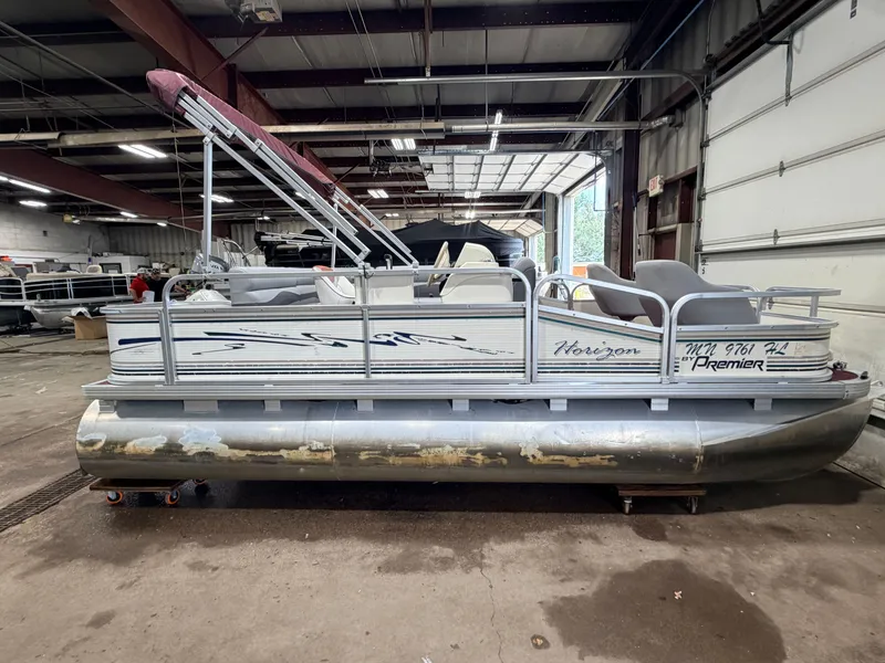 Slide: The Image of A 1998 Premier 180 Horizon pontoon boat with a 40HP Honda 4-stroke engine in a warehouse. - 16