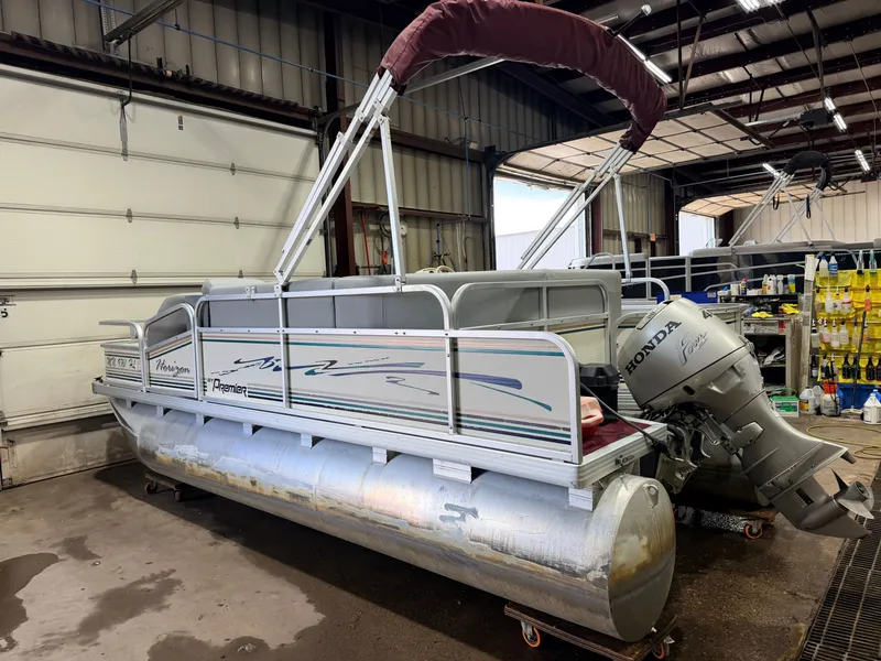 Slide: The Image of A 1998 Premier 180 Horizon pontoon boat with a 40HP Honda 4-stroke engine in a workshop. - 42