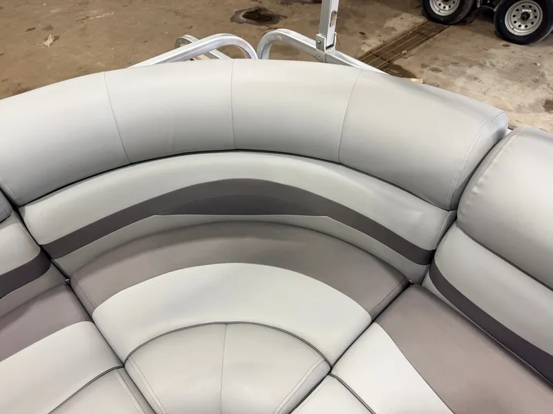 Slide: The Image of Gray and beige upholstery on a boat seat, with a trailer in the background. - 32