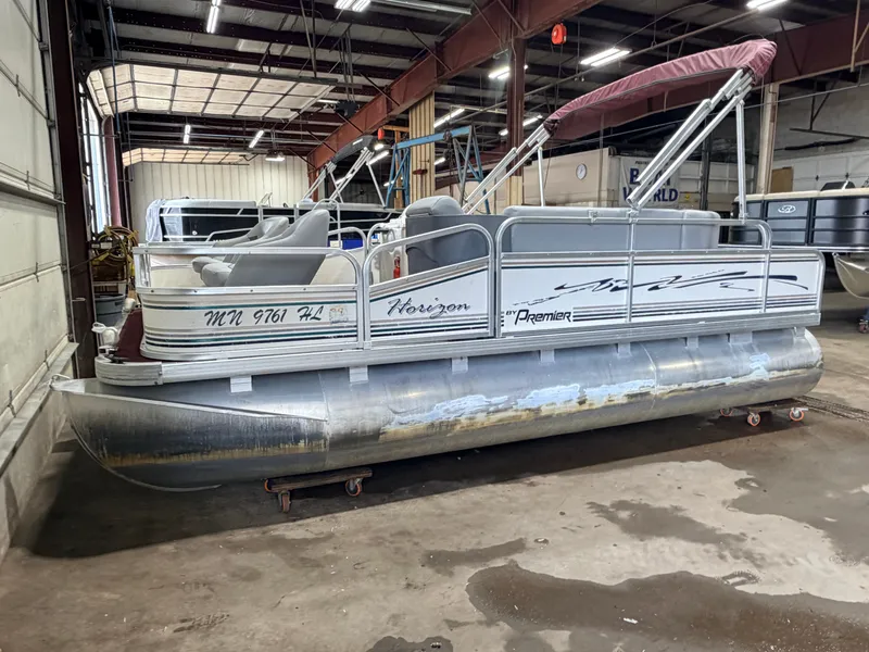 Slide: The Image of A 1998 Premier 180 Horizon pontoon boat with a 40HP Honda 4-stroke engine in a warehouse. - 39