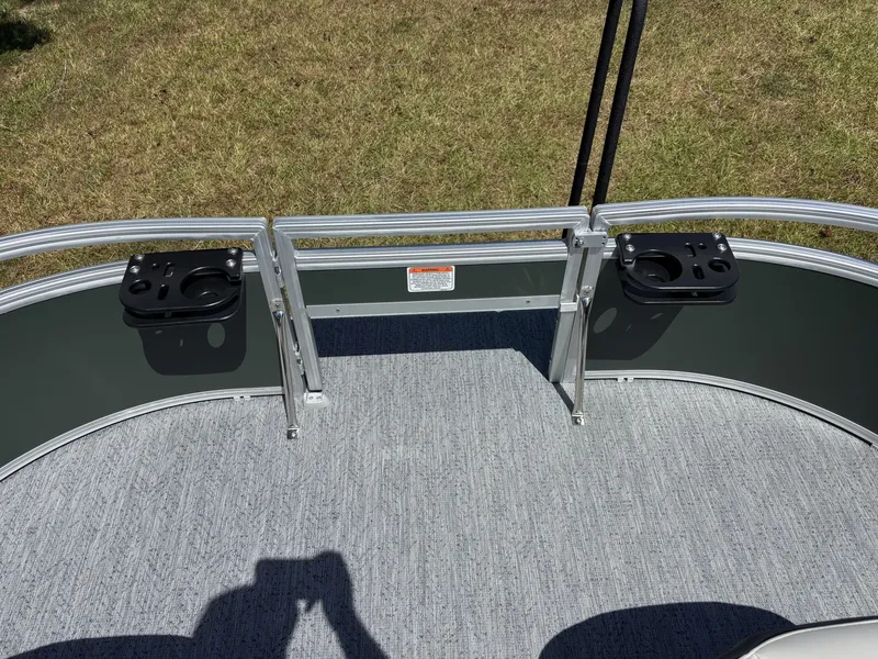 Slide: The Image of Front deck of a Sun Tracker Bass Buggy 16 XL Select with gray carpet flooring. - 14